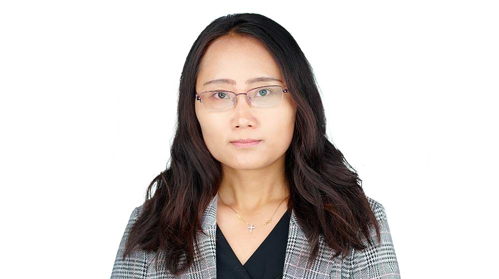 Ning Yang standing in front of a white background