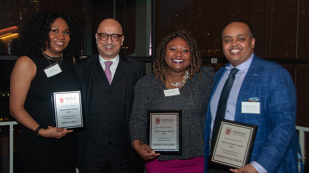 Three award receipients and Dean Behnam with their award plaques Three award receipients and Dean Behnam with their award plaques