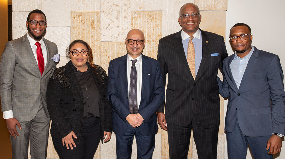 From left to right: Jonathan McGee, Amber Townsend, Michael Behnam, Marquis Miller and Emmanuel Ezeocha stand in front of a polished stone wall From left to right: Jonathan McGee, Amber Townsend, Michael Behnam, Marquis Miller and Emmanuel Ezeocha stand in front of a polished stone wall