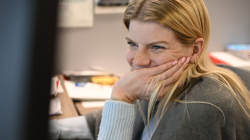 Mimi reimers sitting in an office smiling Mimi reimers sitting in an office smiling